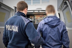 policjanci wykonują czynności z zatrzymanymi