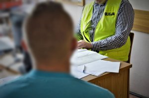policjanci wykonują czynności z zatrzymanymi
