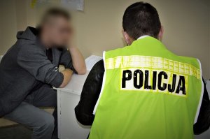 policjant przesłuchuje zatrzymanego